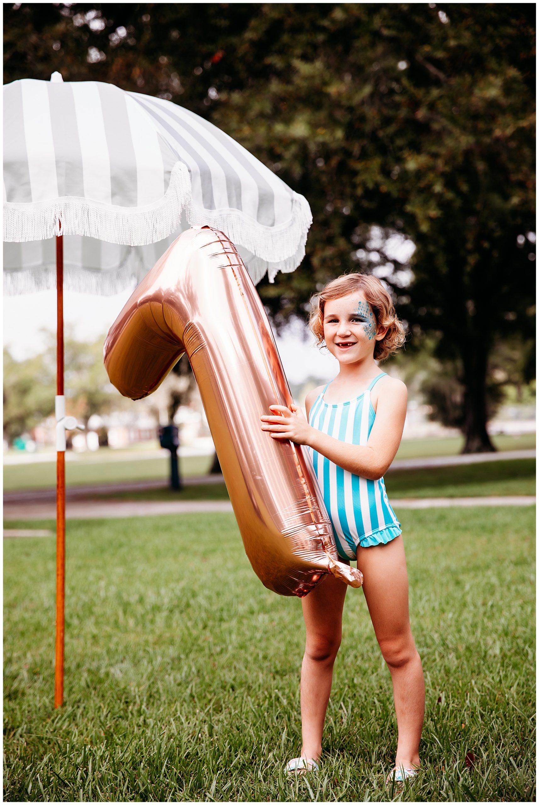 Girl holding a 7 balloon at her birthday party