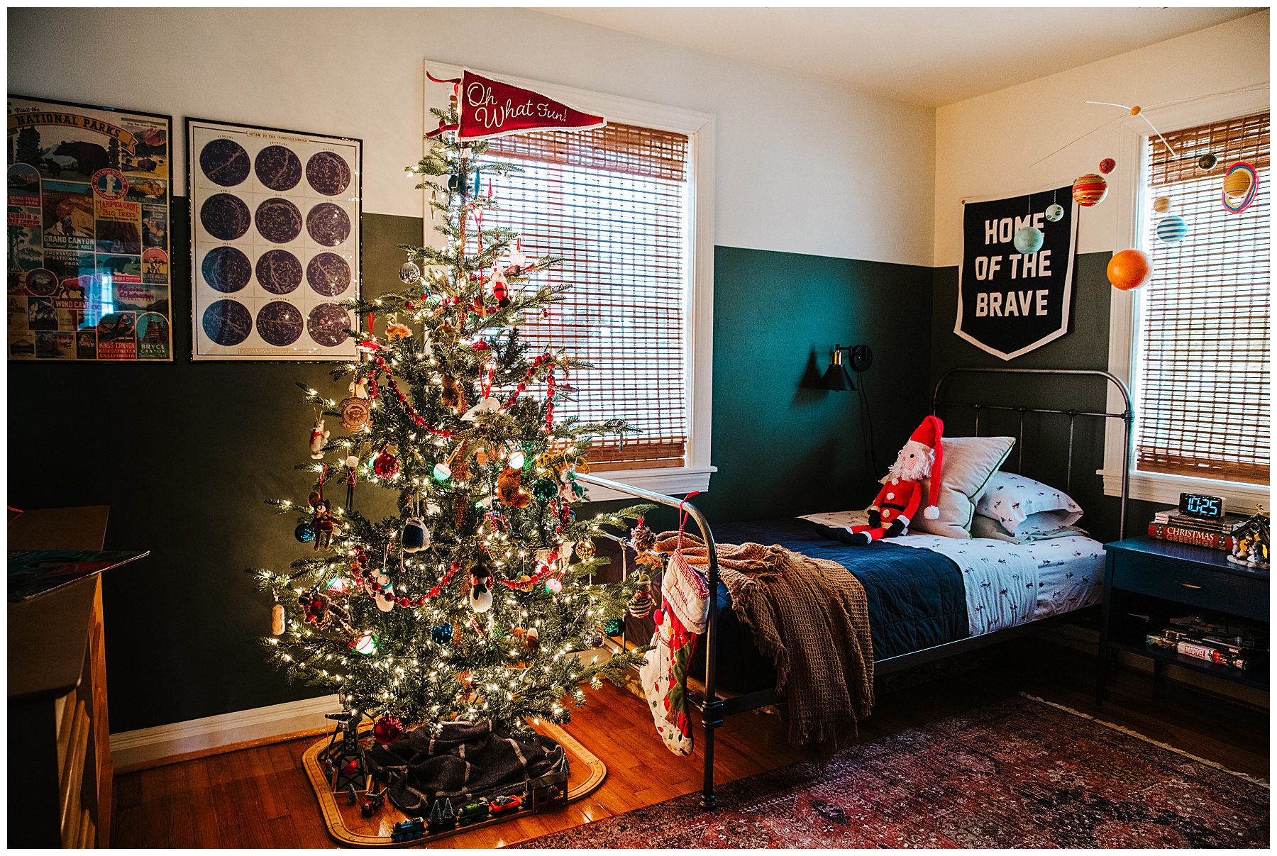 Boys Christmas bedroom showing a 6.5 foot tree at the foot of his bed.